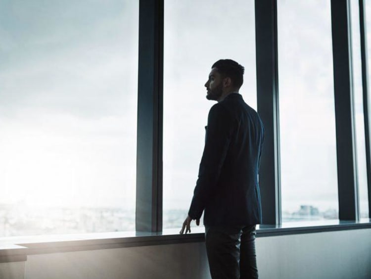 man thinking and looking out of window