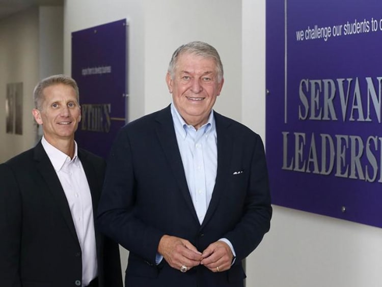 Dr. Gibb and Jerry Coangelo next to CCOB's Servant Leadership pillar