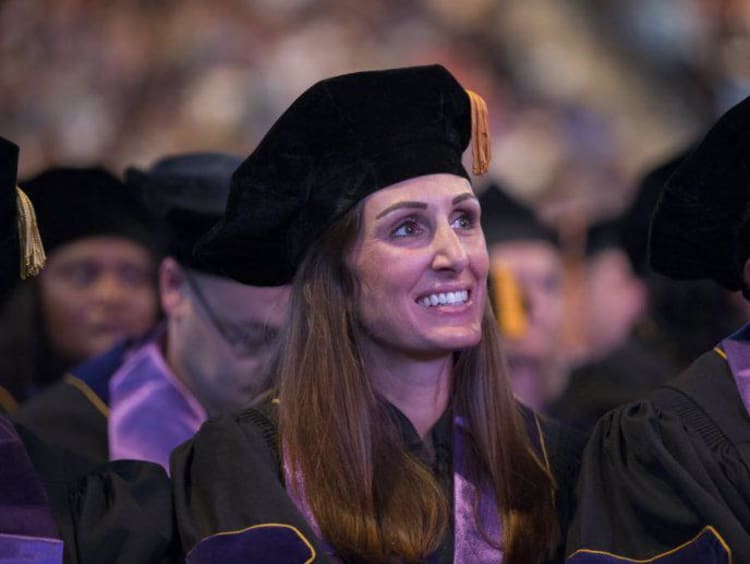 Doctoral graduates listen to commencement speeches