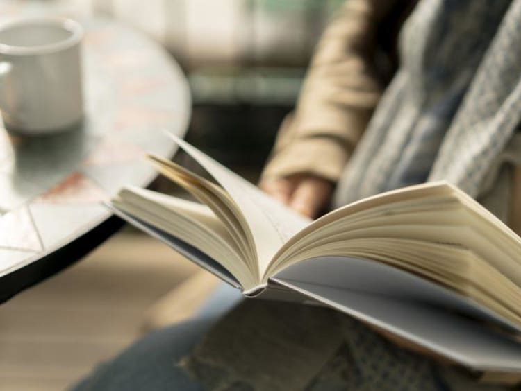 person reading in a coffee shop