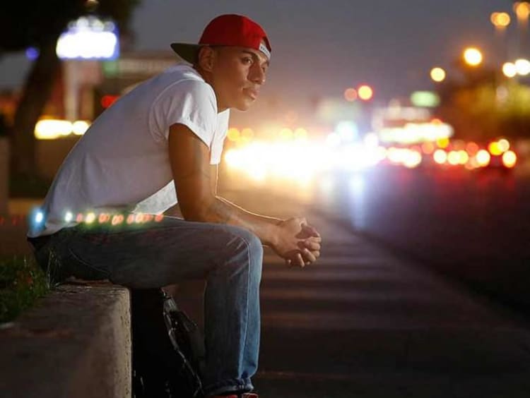 Young person reflecting by a street