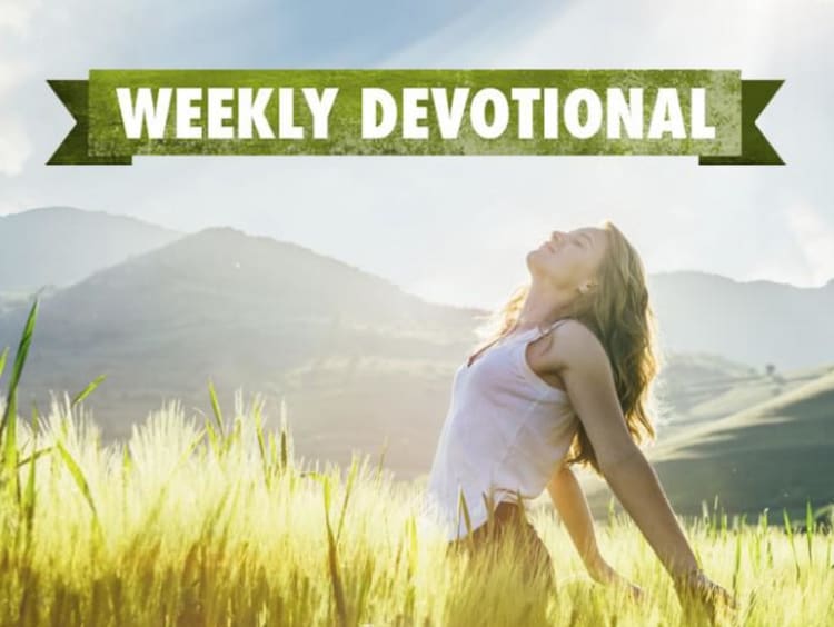 A joyful woman in a field under the Weekly Devotional banner