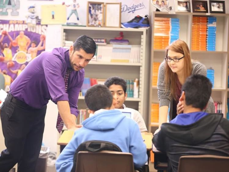 Teacher helping students in classroom