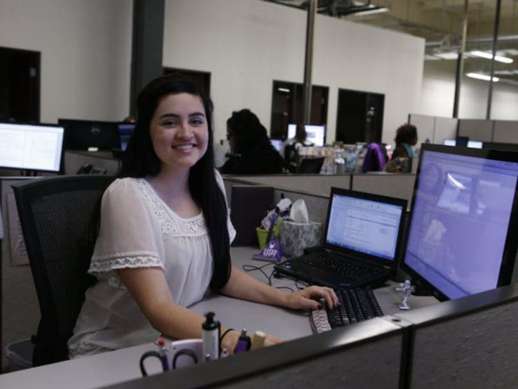 GCU Student worker sitting at desk working on computer