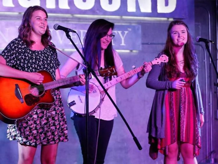 three girls playing instruments