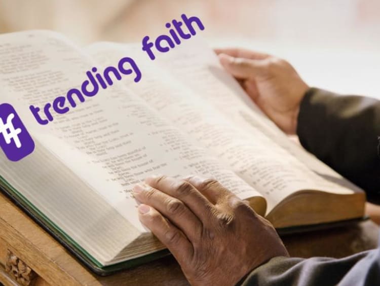 A large Bible on a table under the Trending Faith logo