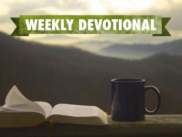 Mountain background with weekly devotional text over open book and coffee mug  