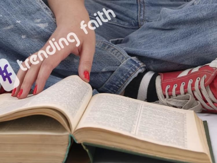 A student reading the Bible under the Trending Faith logo