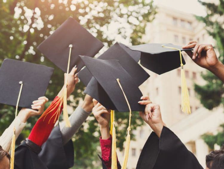 graduation caps in the air