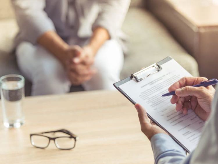 Psychologist with pen and paper in hand