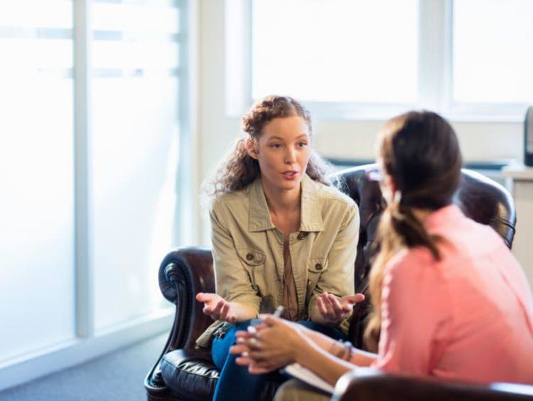 Two counselors facing each other and discussing retention strategies