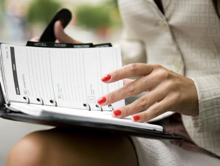 Woman flipping through agenda