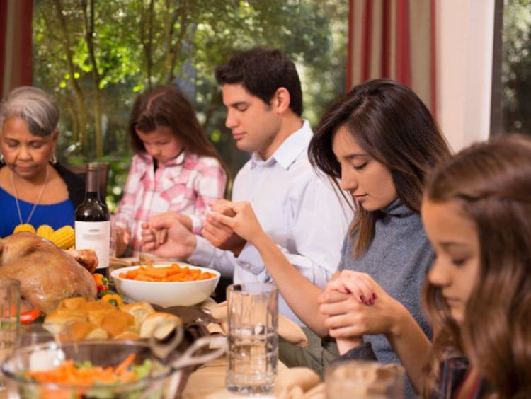 A family at the table on Thanksgiving