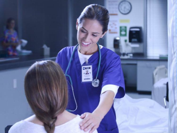 A nurse helping a patient