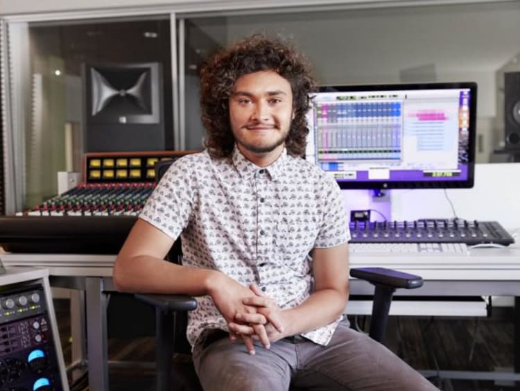 A student working in a sound mixing booth