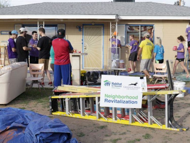 people working on building a house