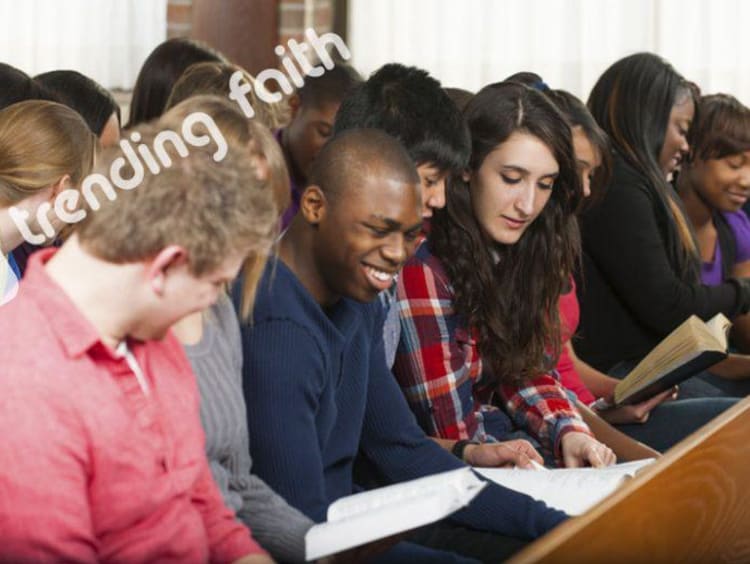 Young Adults gather in church setting gathered over a book 