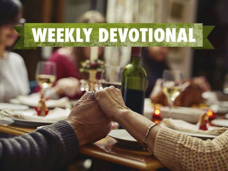 Weekly Devotional: Family praying over a dinner