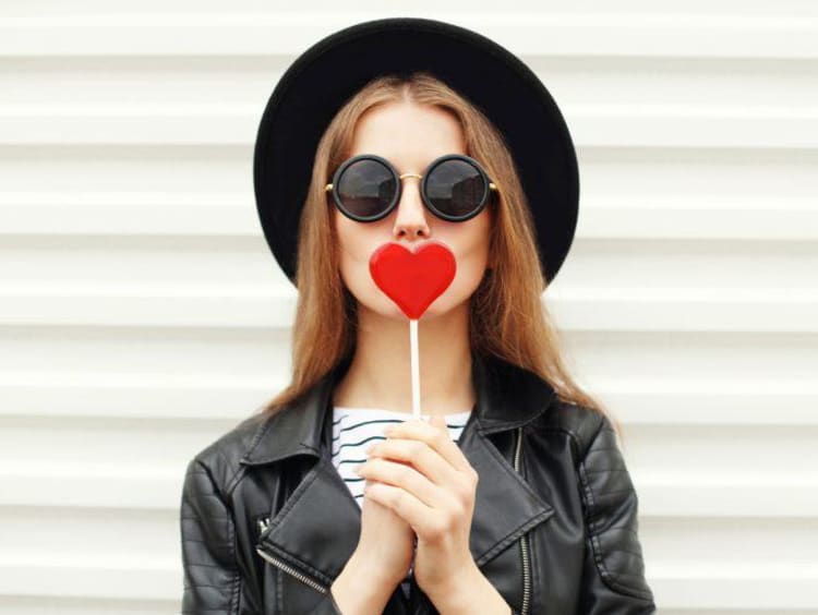 Girl with a heart-shaped lollipop