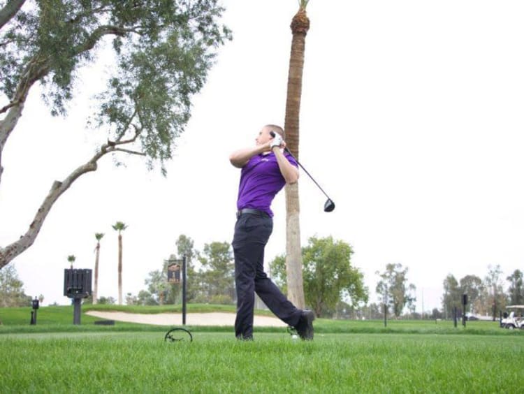 A student athlete playing golf