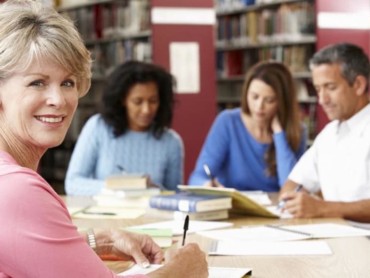 people in the library working together