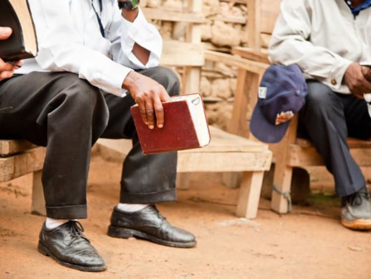 men having a bible study outside