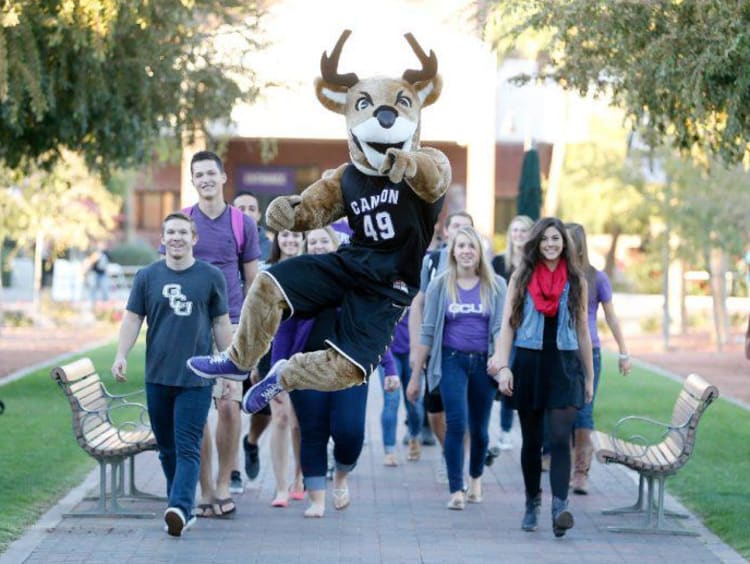 Thunder walking with a group of GCU students on campus