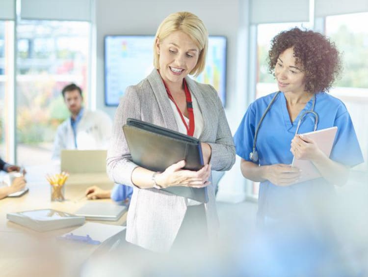 a nurse and administrator talking 