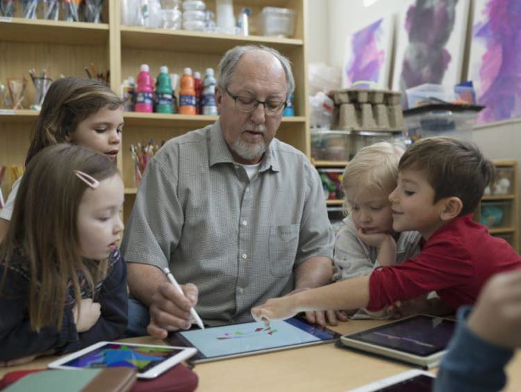 Instructor teaching students on a tablet