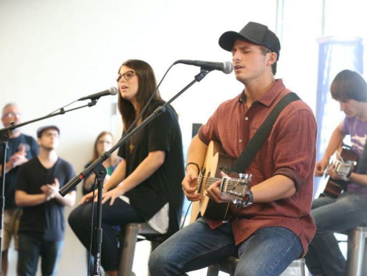 Three students playing music