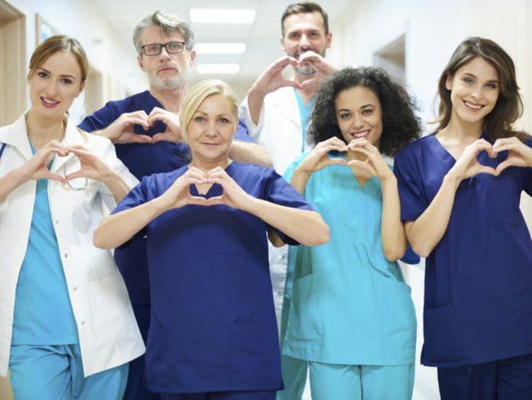 a group of nurses making heart signs