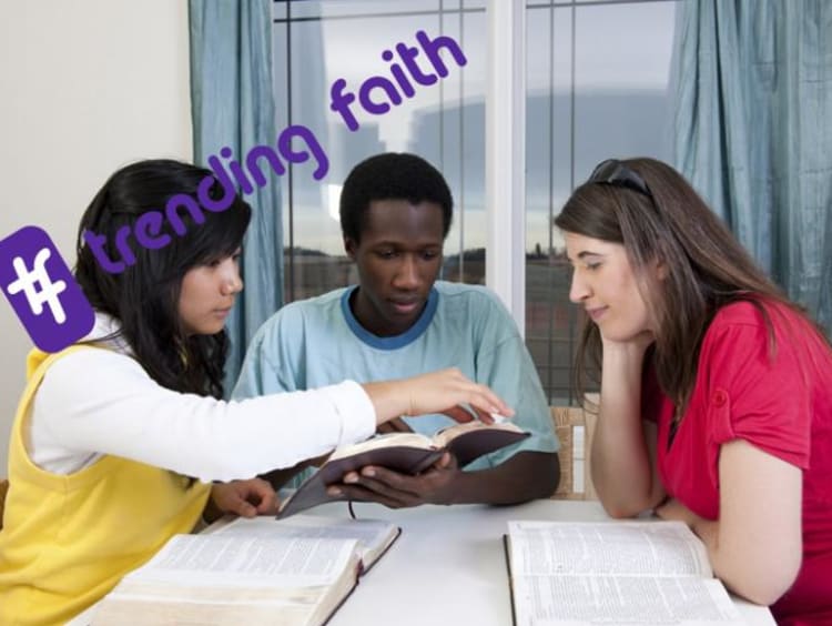 A group of people sitting around a table with the trending faith logo