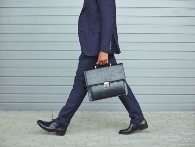 Business man walks on the street with brief case