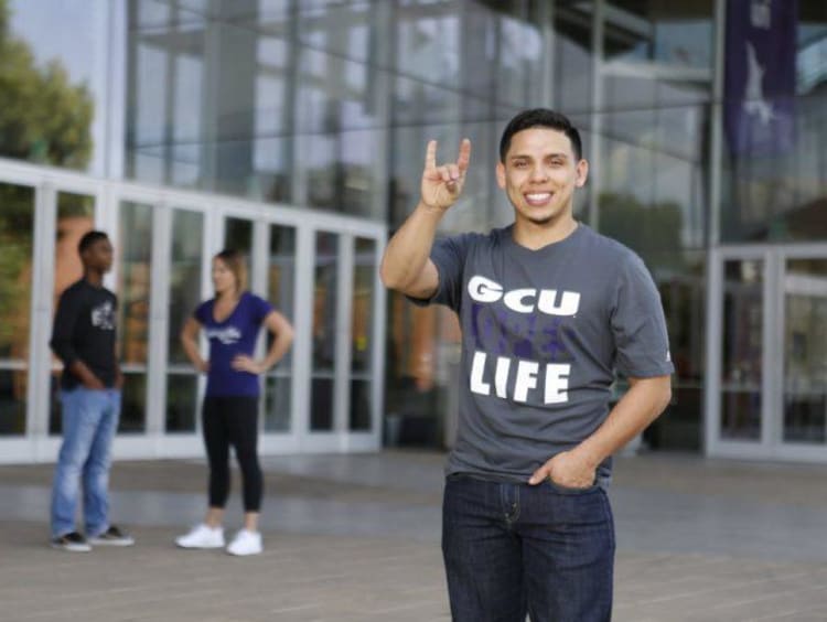 GCU student holding a lopes up