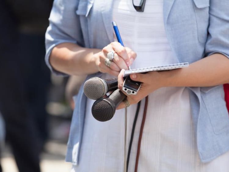 Woman writing on a notepad