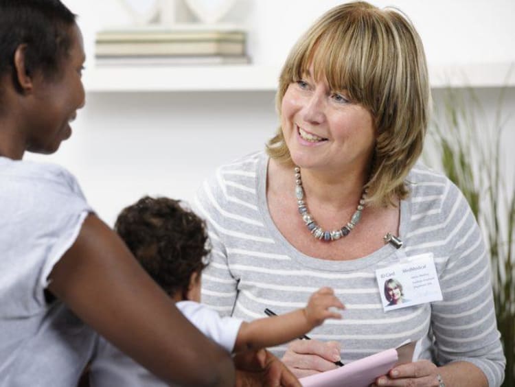 Social worker meets with a guardian and foster child baby