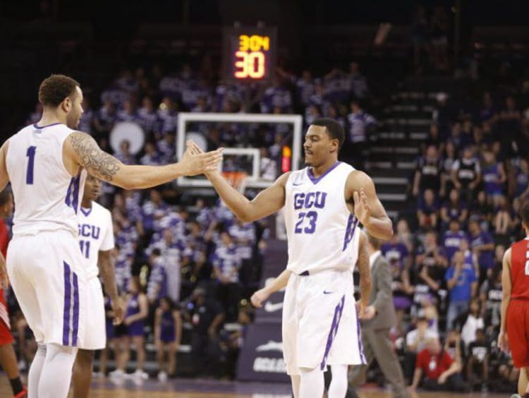 gcu basketball players giving each other a high five