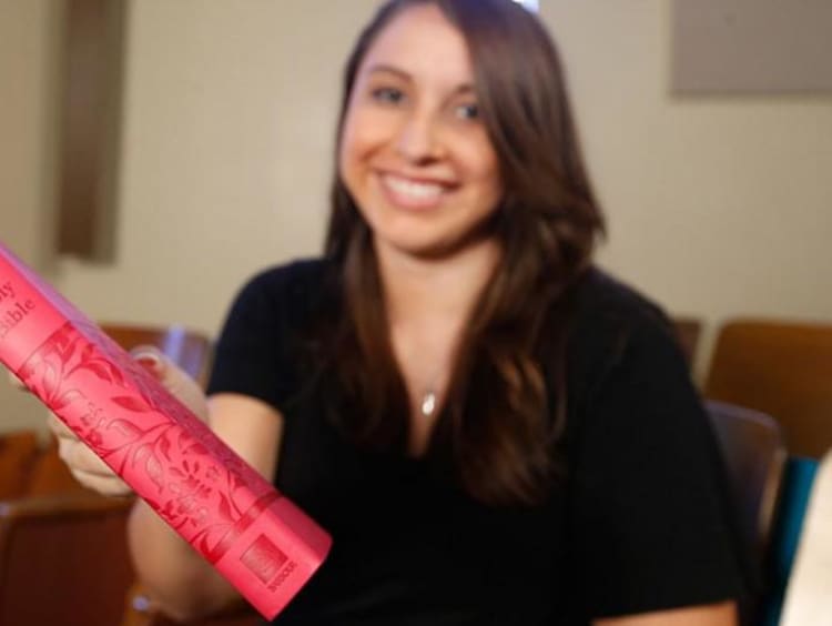 woman holding a bible close to camera