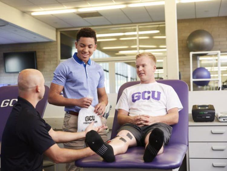 athletic trainer with a patient