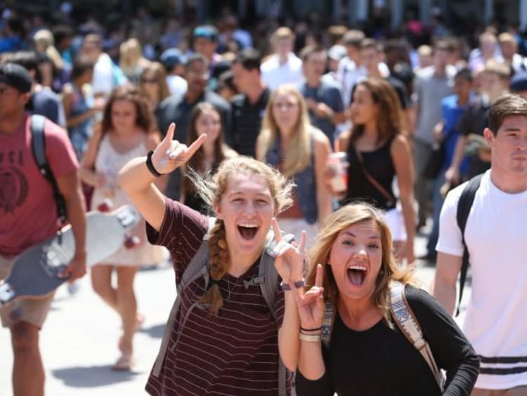 crowd of students, two holding lopes up