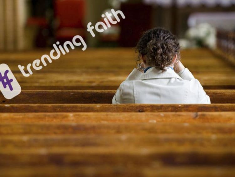 back view of a woman with curly hair siting in church pews