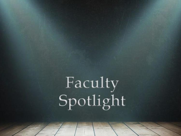 Faculty spotlight text center stage with spotlights on the text