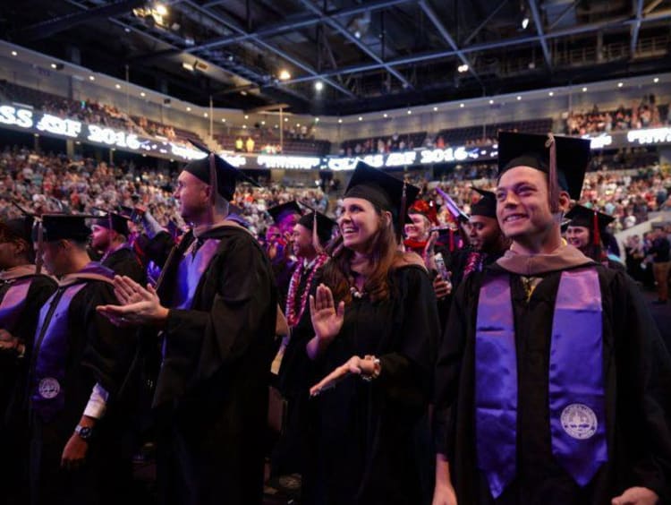 Group of excited honors college graduates at ceremony