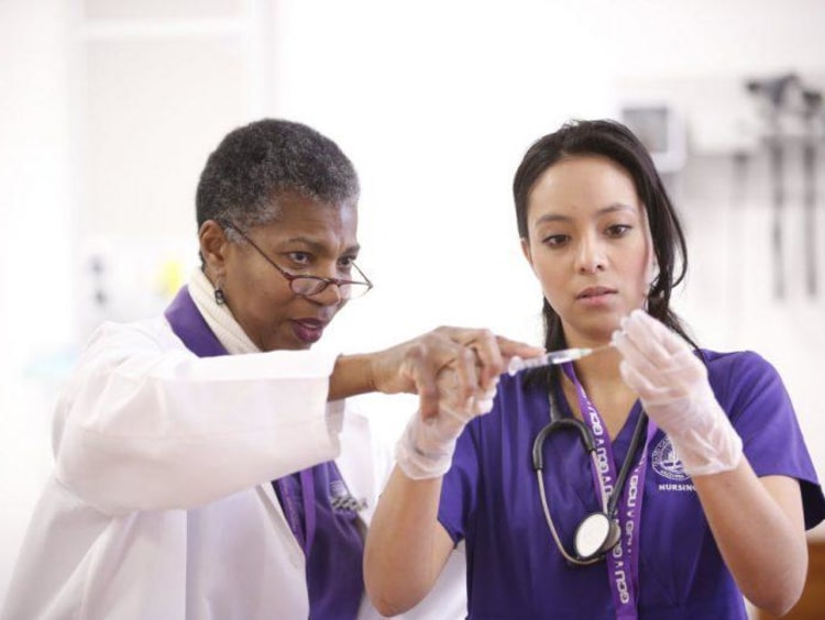 a teacher helping a nursing student