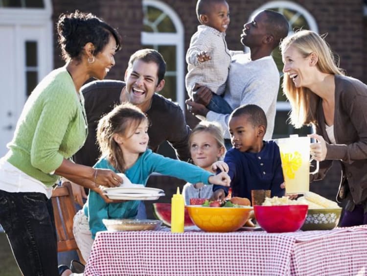 Two families gather for an outdoor cookout