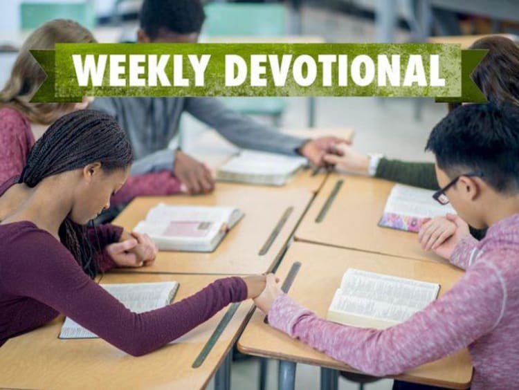 students praying in a group