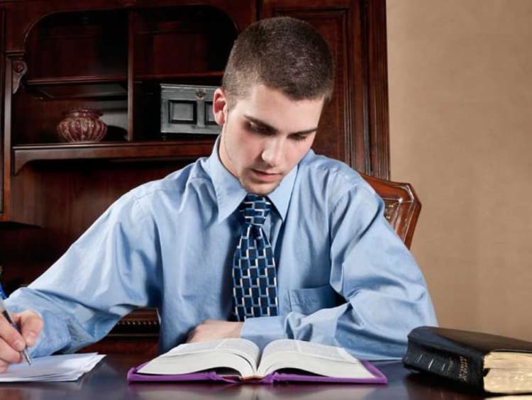 A man reading the Bible at his table