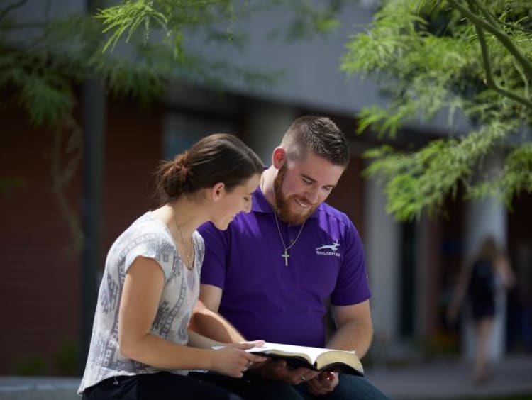 man and woman studying outside