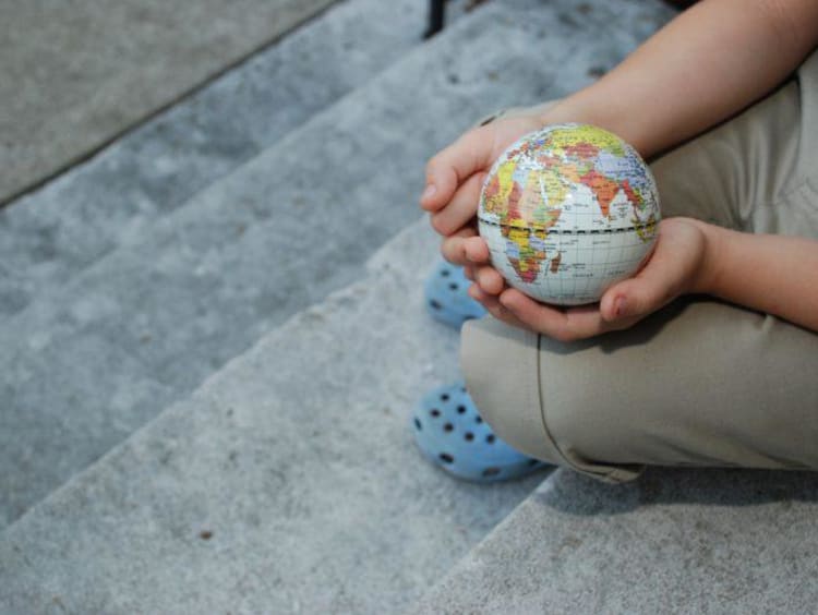 child holding a mini globe