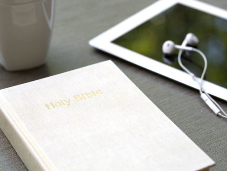 bible and i pad sitting on a table